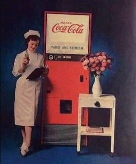 nurse_leaning_on_coca-cola_machine_drinking_Coke.jpeg