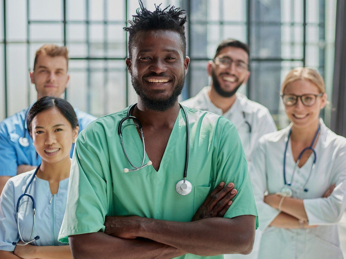 Smiling nursing students in scrubs, enrolled in one of the best BSN programs.