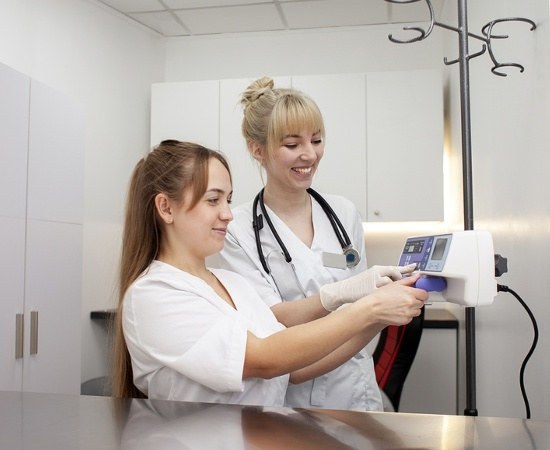 Two nurses reviewing x-rays together during an Associate Degree in Nursing (ADN) program clinical rotation.