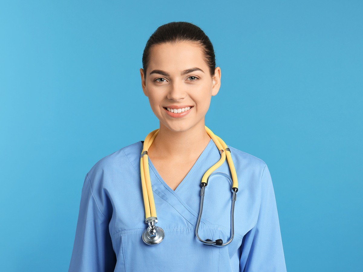 Nursing student in blue scrubs with a stethoscope, preparing for clinical training at a nursing school in Ann Arbor, Michigan.