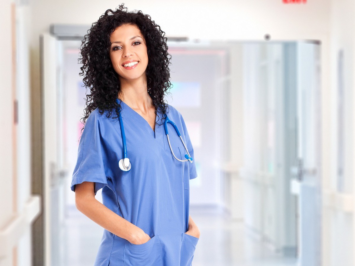 Nursing student in scrubs standing in a hallway at a nursing school in Fort Lauderdale, Florida