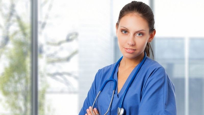 Nursing student in blue scrubs with a stethoscope, preparing for clinical training at a nursing school in Las Vegas, Nevada.