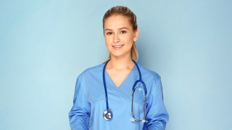 Nurse practitioner student in Arkansas wearing scrubs and a stethoscope, preparing for clinical training in an NP program.