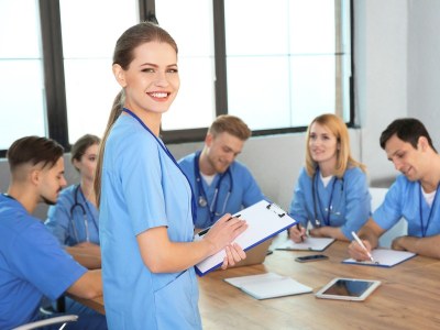 Group of ADN students in Massachusetts in a classroom setting, taking notes and preparing for nursing careers.