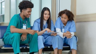 Nursing students in Charlotte, NC reviewing coursework together during clinical training.