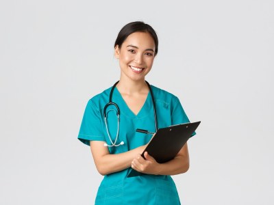 Nursing student enrolled in an ADN program in Georgia, wearing scrubs and holding a clipboard while preparing for clinical training.