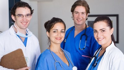 Group of ADN nurses in scrubs beginning their RN to MSN bridge program