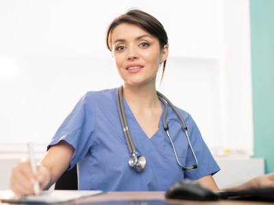 Nursing student in scrubs at a desk in a classroom at a nursing school in Nashville, Tennessee.