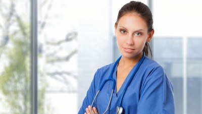 Nursing student in blue scrubs with a stethoscope, preparing for clinical training at a nursing school in Las Vegas, Nevada.