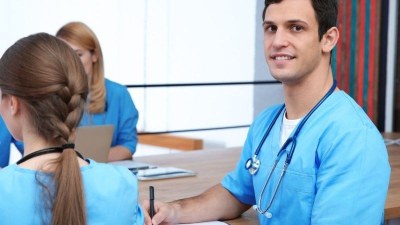 Nursing students in blue scrubs attending class in Tampa, Florida, preparing for local nursing programs.