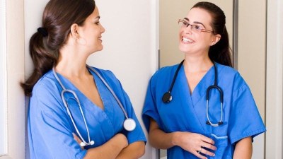 Nursing students in blue scrubs studying in Roanoke, Virginia.