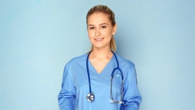 Nurse practitioner student in Arkansas wearing scrubs and a stethoscope, preparing for clinical training in an NP program.
