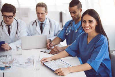 A group of nurses sitting at a table working on coursework in a DNP program in New Jersey.