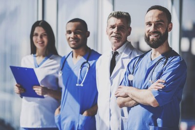 A group of nurses standing and smiling in a DNP program in Georgia.