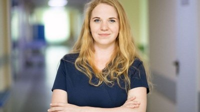 Student in nursing scrubs enrolled in one of the cheapest licensed practical nurse programs.