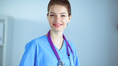 Portrait of a smiling nurse pursuing a 12-month FNP program